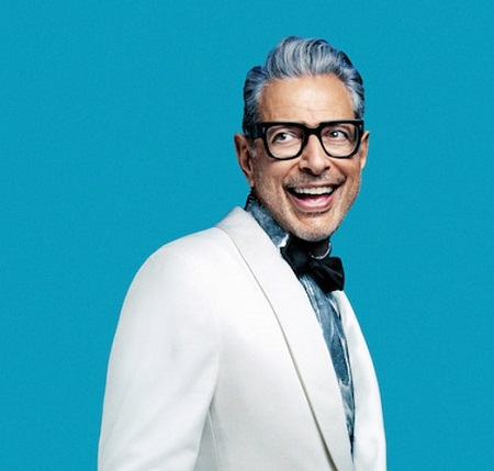 Jeff Goldblum in a white suit poses for a picture.